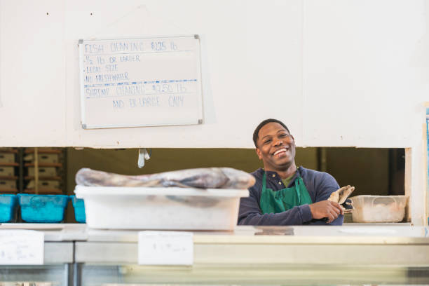 istock Black man working in seafood market 690603980