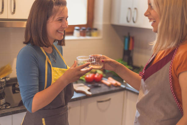 istock Happy lesbian couple toasting in kitchen 690606586