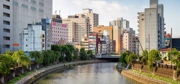 Utsunomiya Japan Downtown skyline with Ta river photographed early morning. The canal is lined with tall office and apartment buildings.