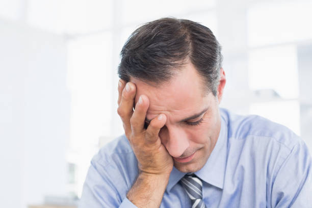 istock Frustrated businessman working in his office 690611588
