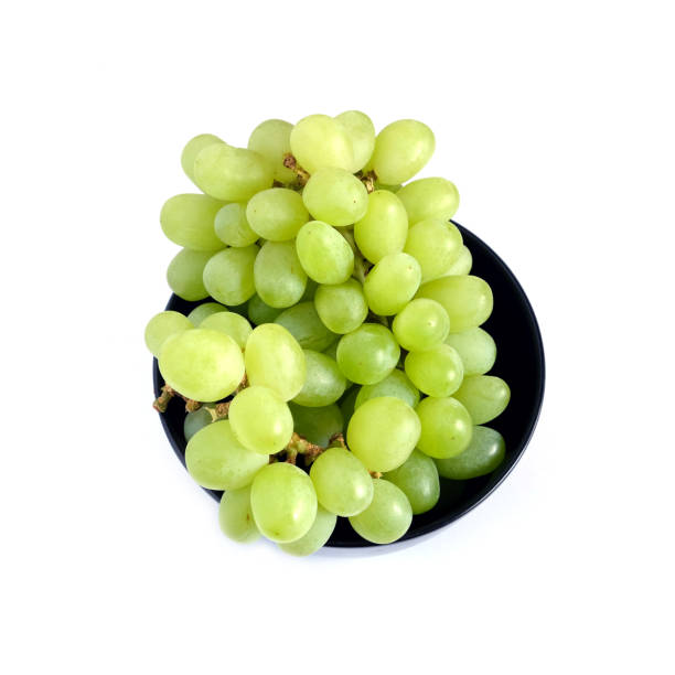 istock Ripe green grape berries in black round bowl top view 690622354