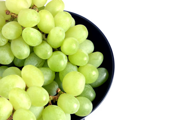 istock Ripe green grape berries in black round bowl top view 690623058