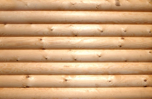 Background of horizontal hewed smooth wooden logs close up