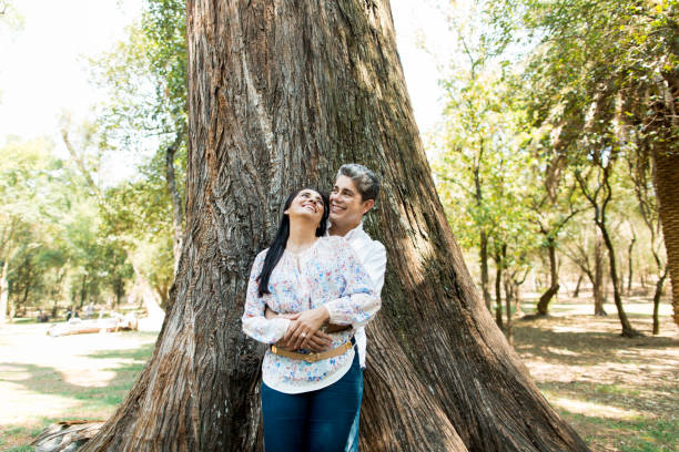 istock Cheerful mature couple standing and leaning on tree 690651056