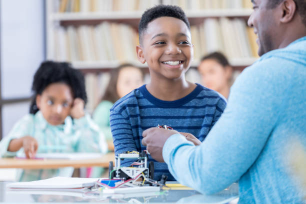 istock Happy preteen boy in technology class 690657042