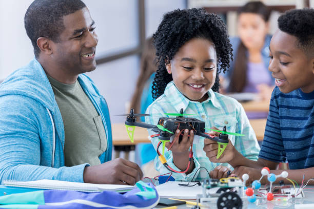 istock Cheerful STEM middle school students build drone 690657098