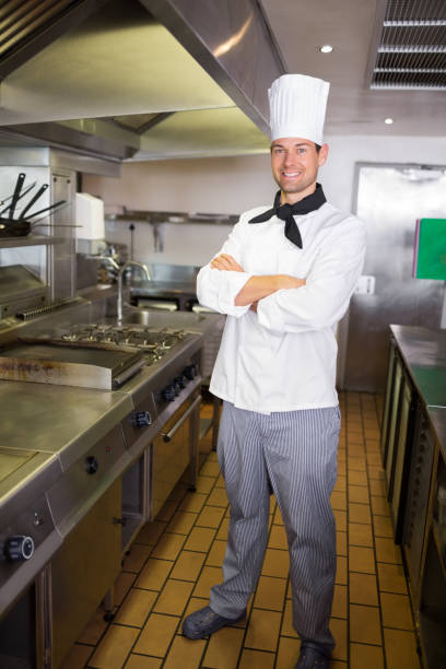 istock Smiling male cook with arms crossed in the kitchen 690659652