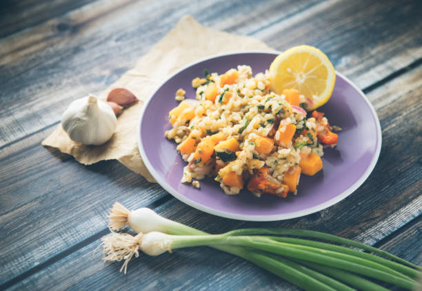 Healthy butternut squash garden peas risotto with garlic, onion and lemon