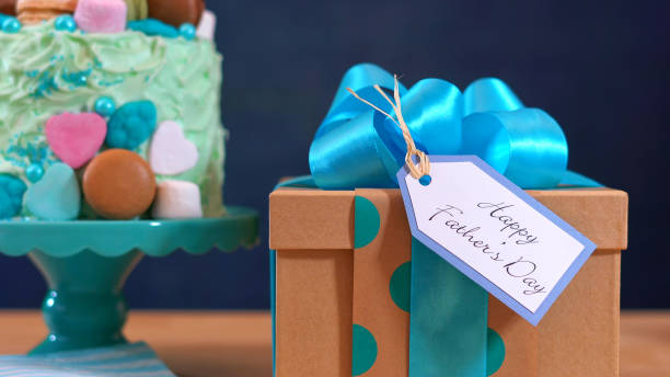 istock Fathers Day party table with cake and gifts. 690662222