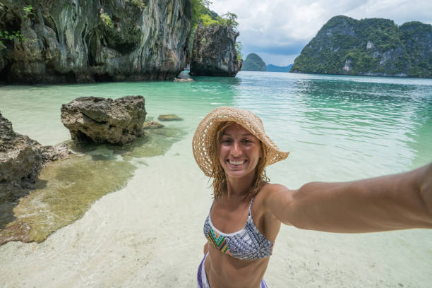 istock Blond girl on vacations taking selfie portrait 690664734