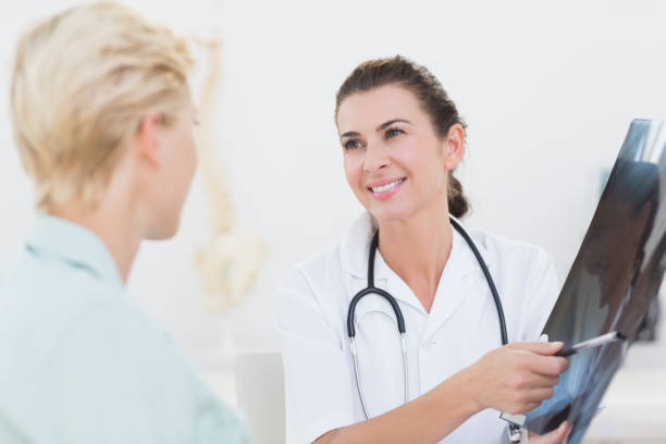 istock Doctor showing Xray to her patient 690665092