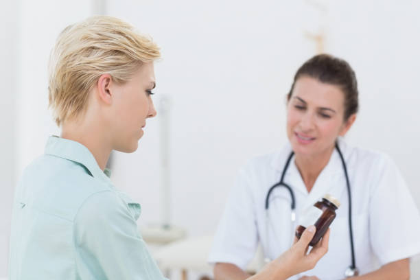 istock Patient looking at medication with her doctor 690667106