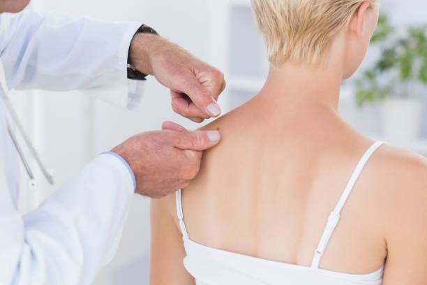istock Doctor examining his patient back 690667484