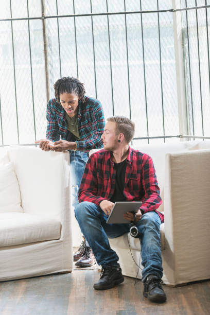 istock Two multi-ethnic young men in plaid shirts talking 690672422