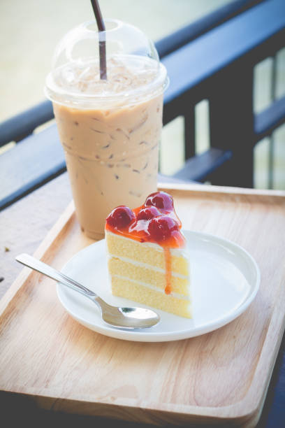 istock Sponge cake with cherry syrup. Peace of cherry cake serve with iced coffee 690675952