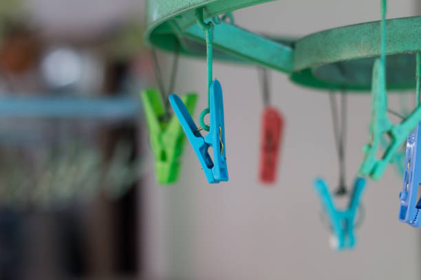 istock Clothes pegs or clothespins hang on washing line.(selective focus) 690675968