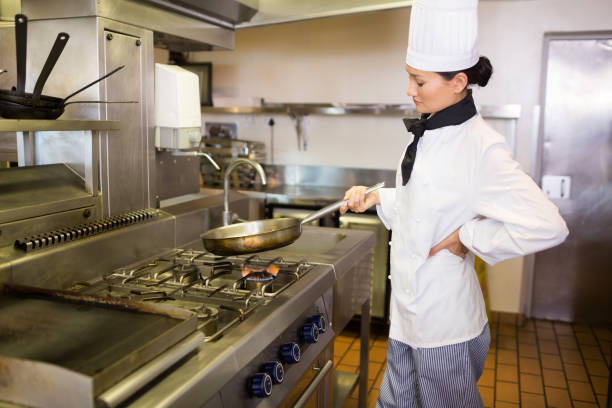 istock Female cook preparing food in the kitchen 690687270