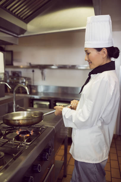 istock Female cook preparing food in kitchen 690687306