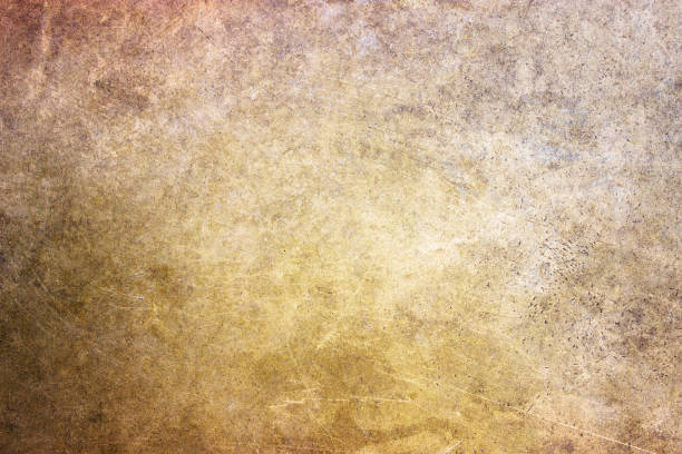 istock bronze texture, golden hue metal surface as a background 690690316