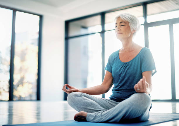 istock Practising mindfulness through yoga and meditation 690716864