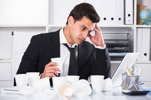 istock Businessman feeling thirsty in hot office 690716912