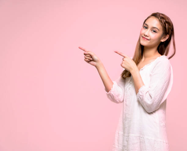 young latina girl pointing to the left