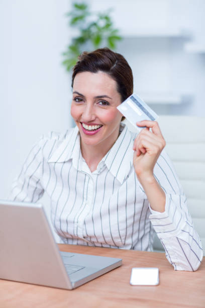 istock Pretty brunette businesswoman using her credit card 690727384