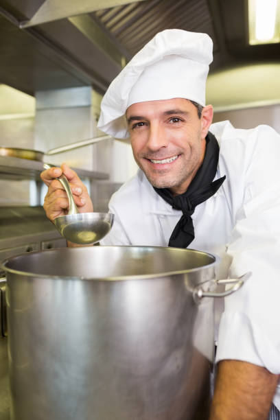 istock Smiling male cook tasting food in kitchen 690727390