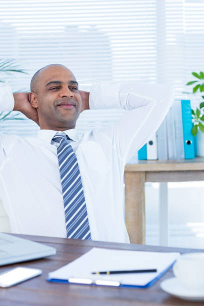 istock Relaxed businessman lying down in swivel chair 690730916