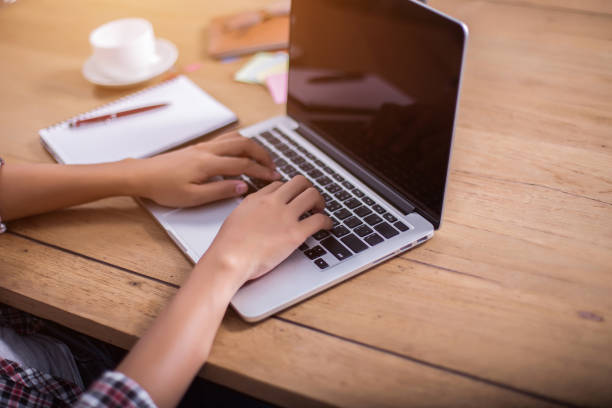 istock business woman writing something on notepad in office. 690733868
