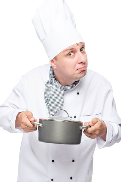 istock cheerful chef posing with a black pot on a white background 690737436