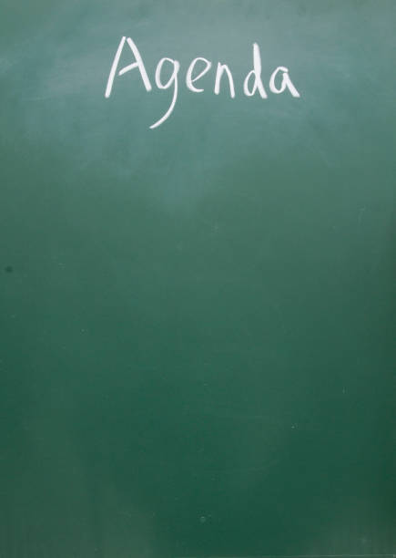 istock agenda  title handwritten with chalk on blackboard 690742068