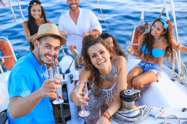 istock Friends drinking champagne on yacht at sunset 690758618