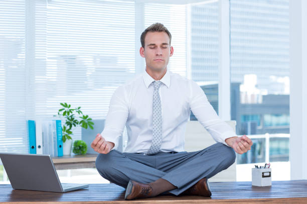 istock Zen businessman doing yoga meditation 690761140