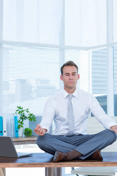 istock Zen businessman doing yoga meditation 690761164
