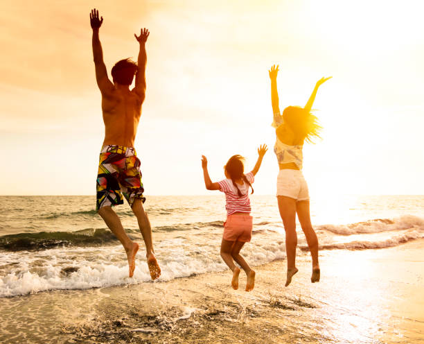 istock happy Family jumping on the beach 690761384