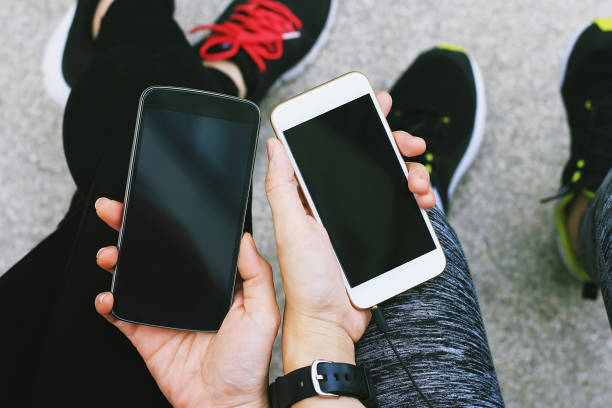 istock Two young girls using smart phone at the outdoors, Friends chattering with mobile application. 690761578