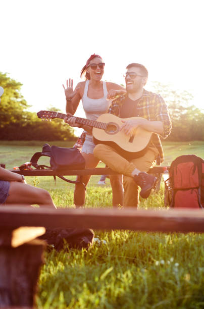 istock Young people  camping playing guitar outdoor 690761648