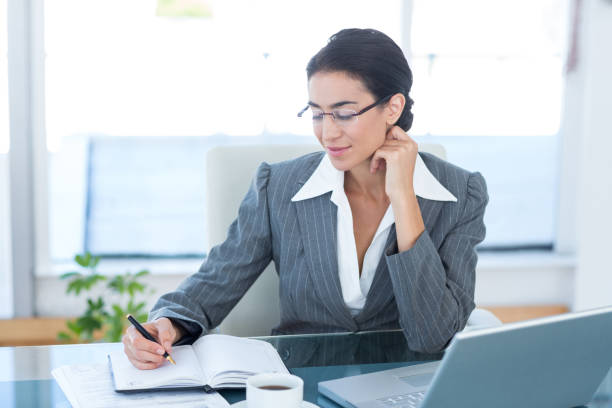 istock Businesswoman working with her laptop and writing notes 690767070