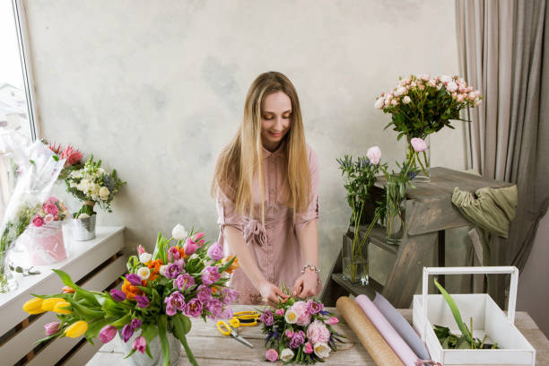 istock Florist in the workshop packs a bouquet 690767222