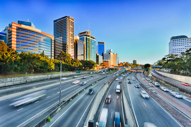 Wide view of multi lane Warringah freeway going through North SYdney during morning rush hour traffic peak and congestion in Australia.