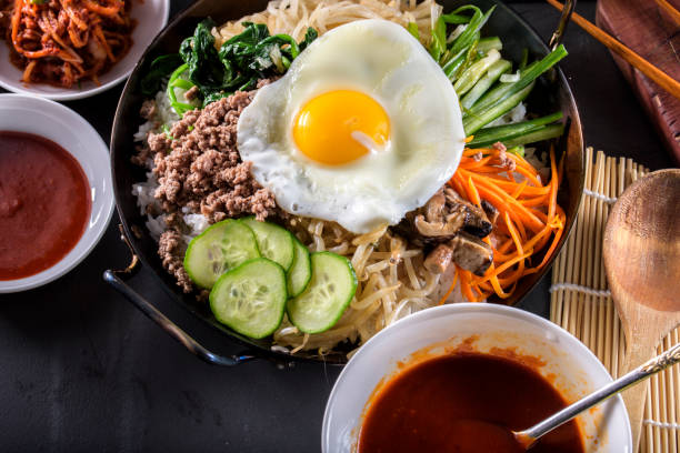 istock BI Bim Bap, Rice with Mixed Vegetables, top view with Hot Sauce in Cast Iron Pot 690787770