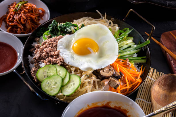 istock BI Bim Bap, Rice with Mixed Vegetables, top view with Hot Sauce in Cast Iron Pot 690789874