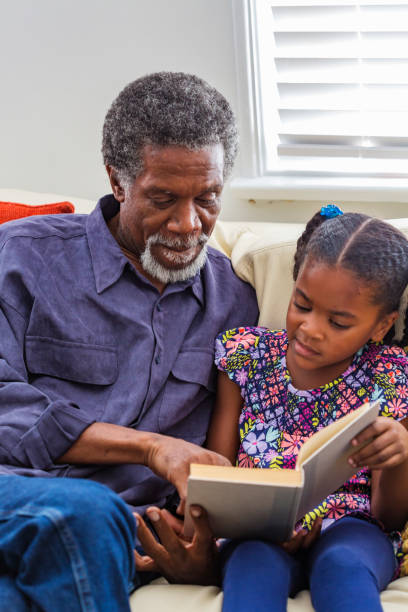 istock Grandfather Reading to Grand Children 690793522