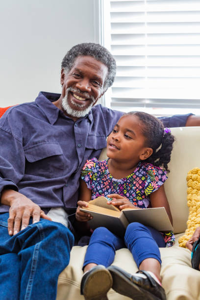 istock Grandfather Reading to Grand Children 690793536