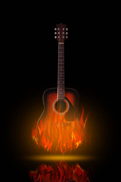 istock Acoustic guitar on fire on black background 690793600