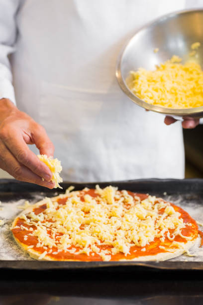 istock Mid section of a male chef preparing pizza 690793968