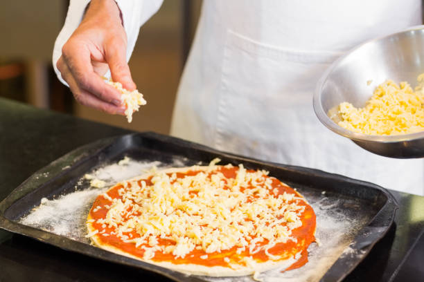 istock Mid section of a chef preparing pizza 690793988
