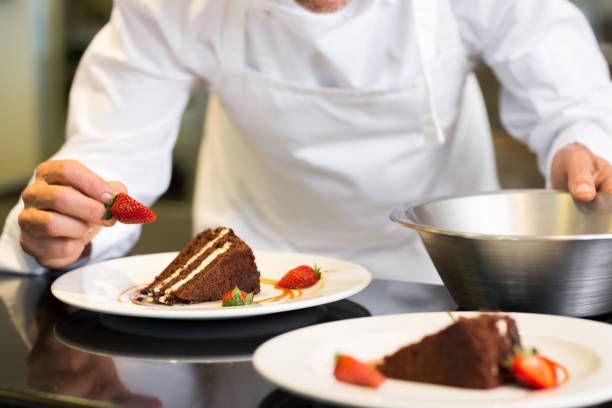 istock Mid section of pastry chef decorating dessert 690796548