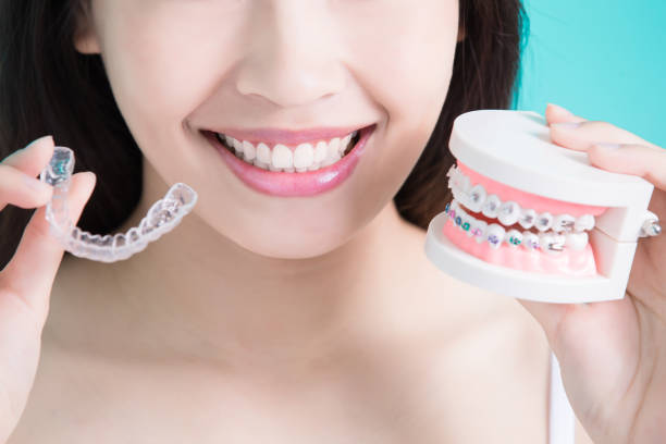 healthy dental concept woman choicce different brace on green background brace stock pictures, royalty-free photos & images